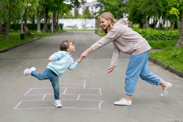 Mother and child in front of a hopscotch draw