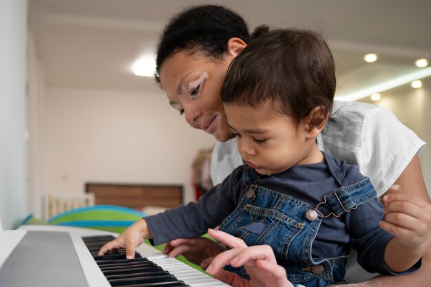 Mother and child playing piano