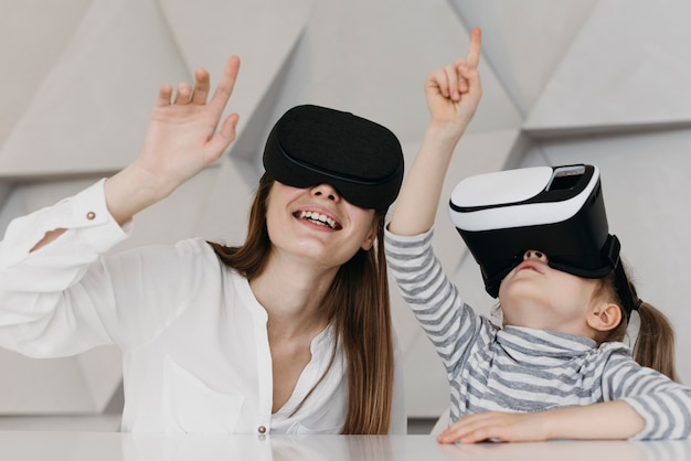 Mother and child using virtual reality headset and pointing up