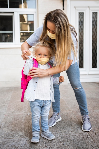 Free photo mother and child with medical masks