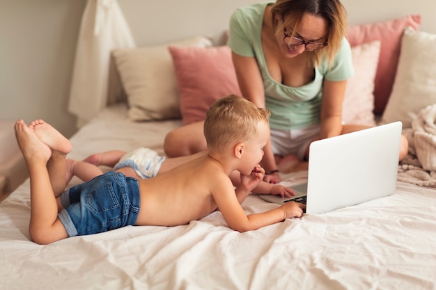 Mother and children looking at laptop