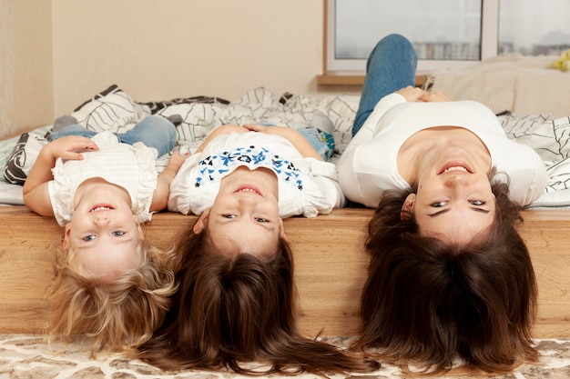 Mother and childrens in bed playing