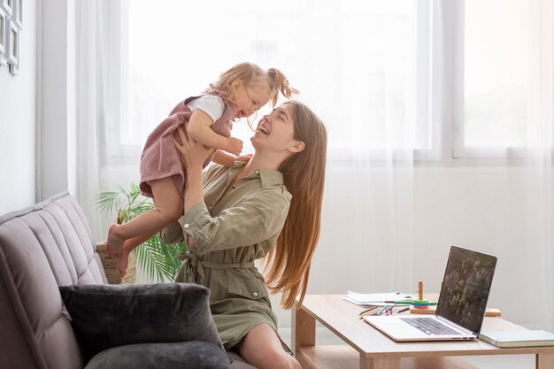 mother on couch holding girl