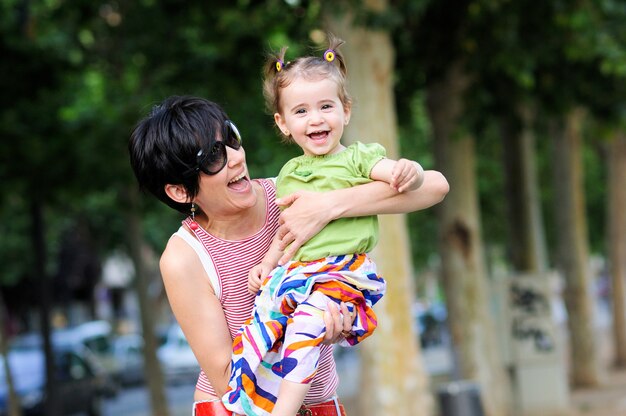 Mother cuddling her daughter in the park