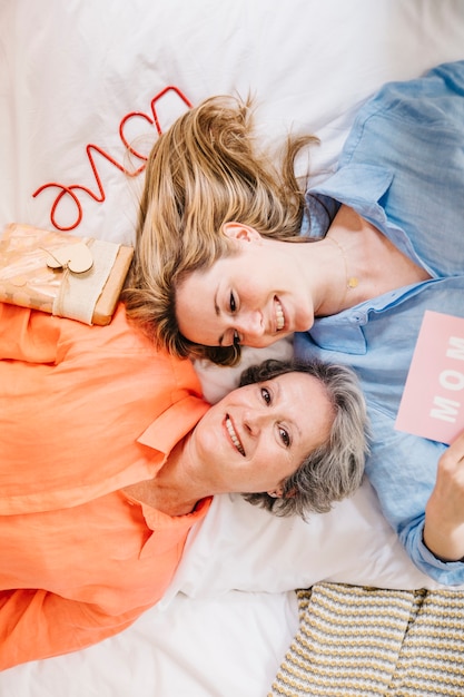 Mother and daughter on bed