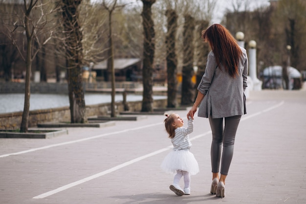 Mother and daughter by lake