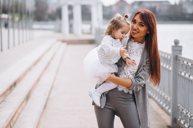 Mother and daughter by lake