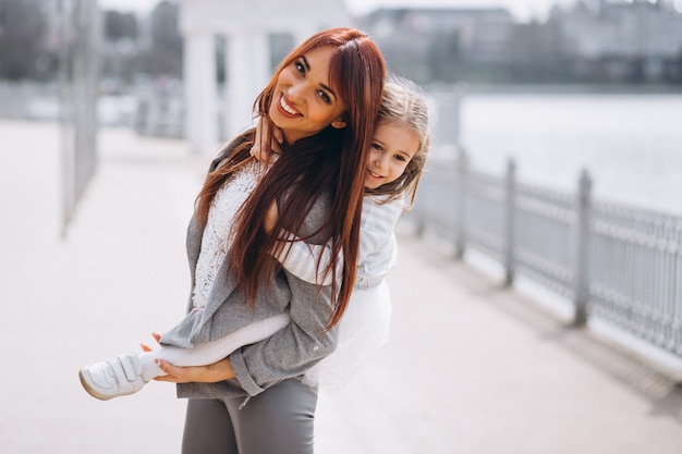 Mother and daughter by lake