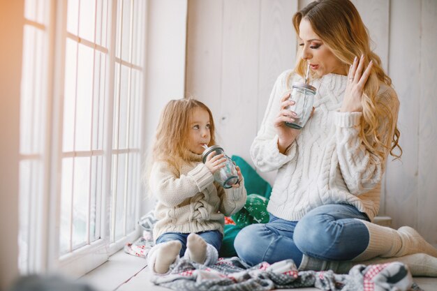 mother and daughter by the window