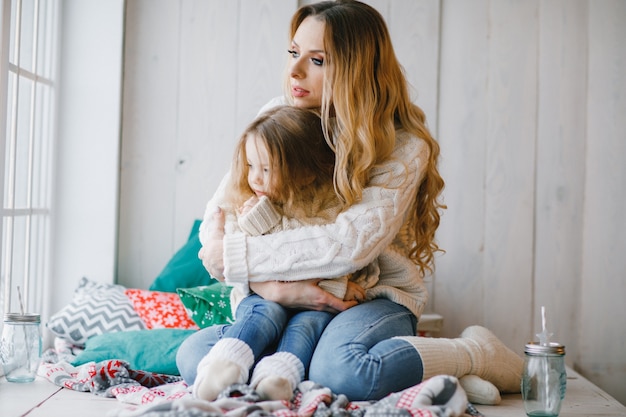 mother and daughter by the window