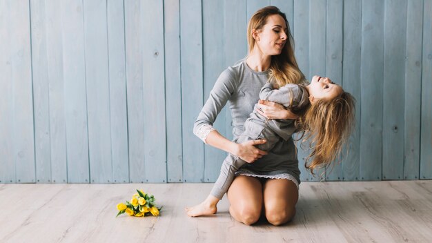 Mother and daughter celebrating mothers day on the floor