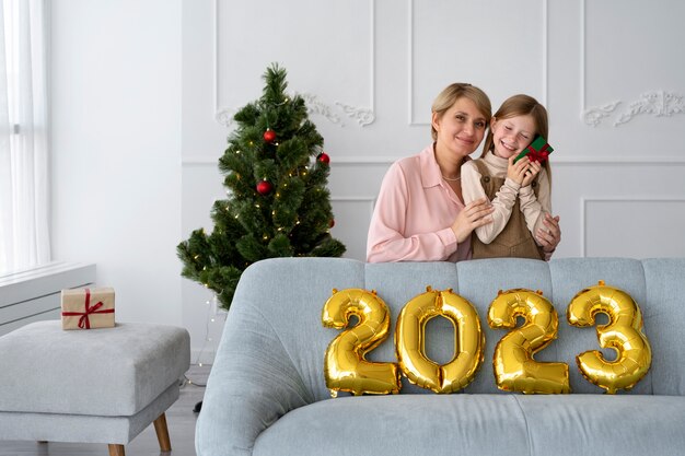 Mother and daughter celebrating new years eve at home together