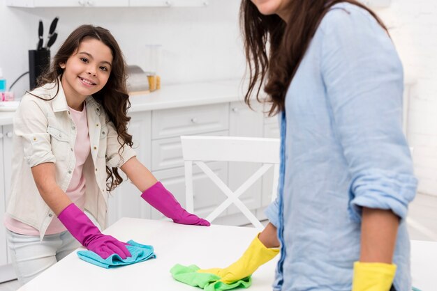 Mother and daughter cleaning the kitchen together