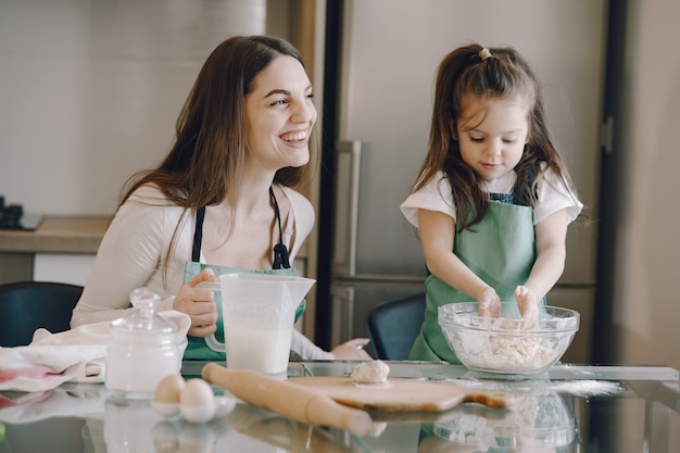 Mother and daughter cook the dough for cookies