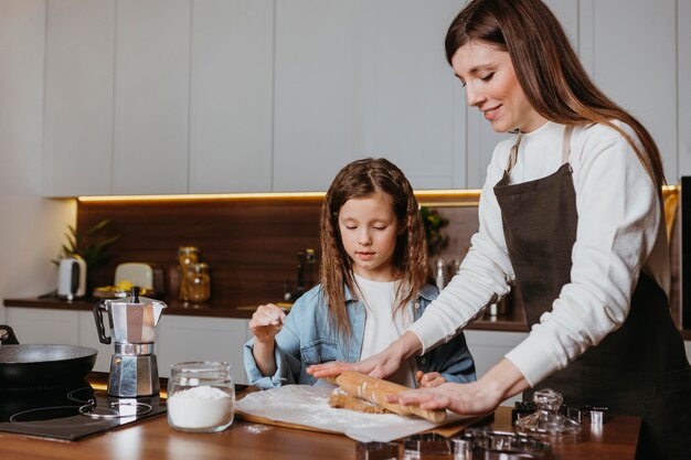 Mother and daughter cooking in the kitchen at home