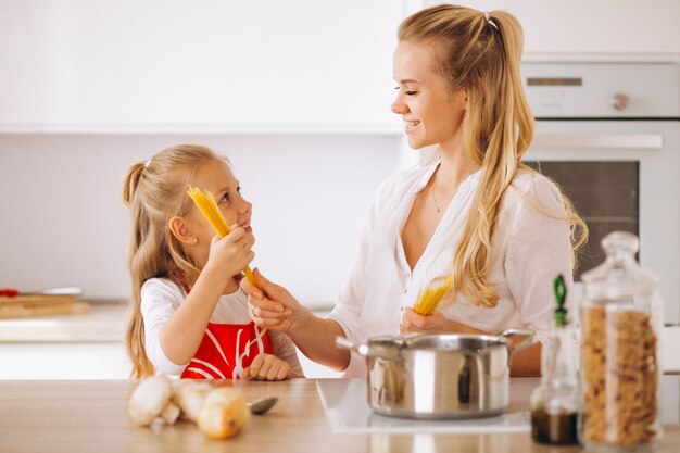 Mother and daughter cooking pasta