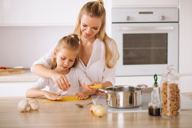 Mother and daughter cooking pasta