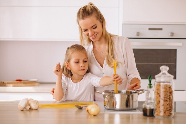 Mother and daughter cooking pasta