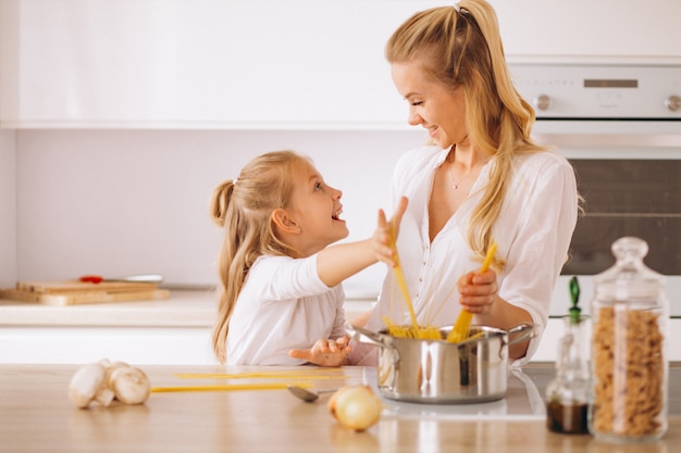 Mother and daughter cooking pasta