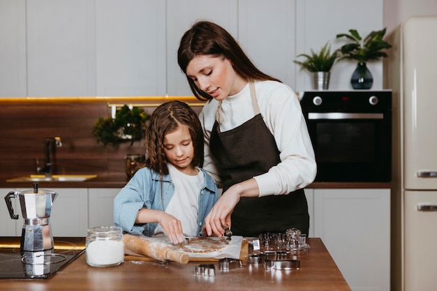 Mother and daughter cooking together in the kitchen
