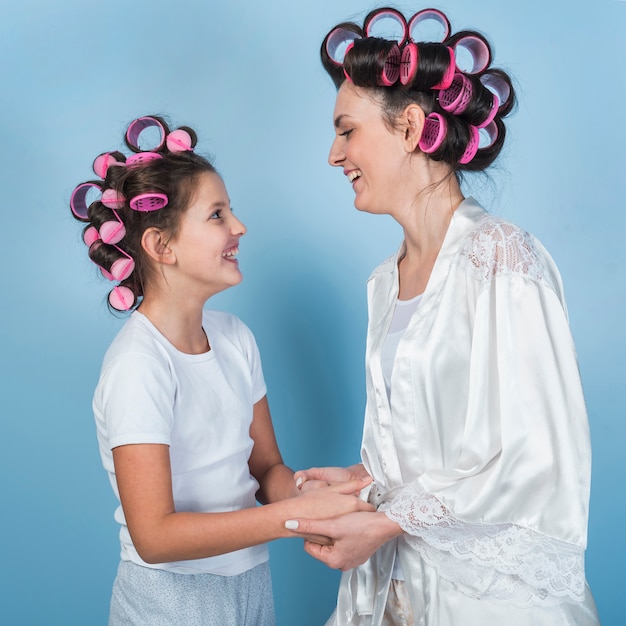 Mother and daughter in curlers laughing