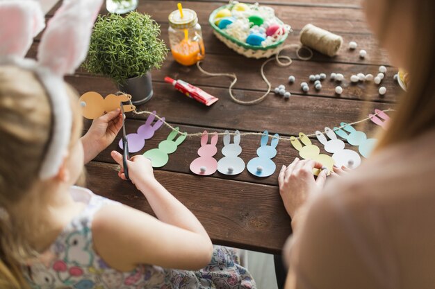 Mother and daughter cutting bunnies from paper