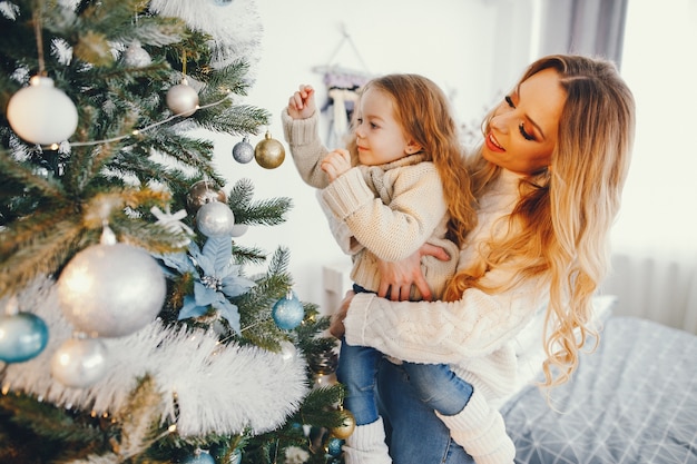 mother and daughter decorating the tree
