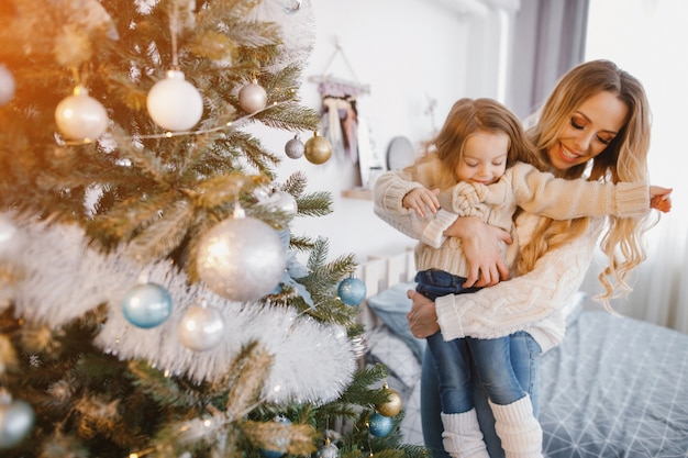 mother and daughter decorating the tree