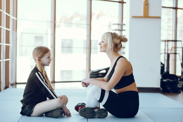 Mother and daughter doing yoga in a yoga studio