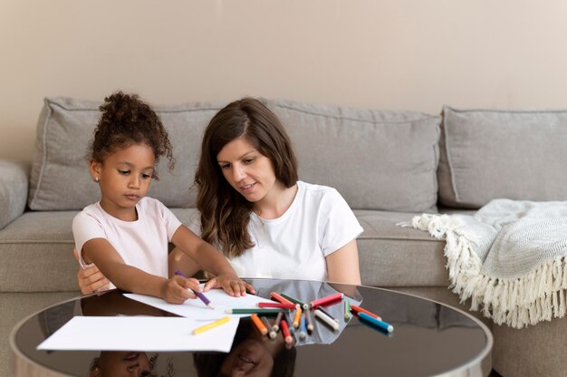 Mother and daughter drawing together