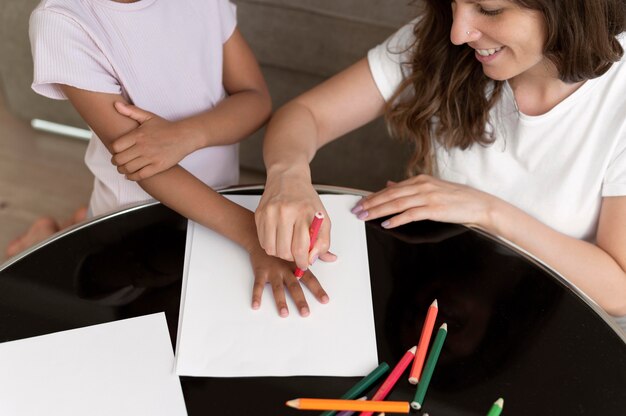 Mother and daughter drawing together