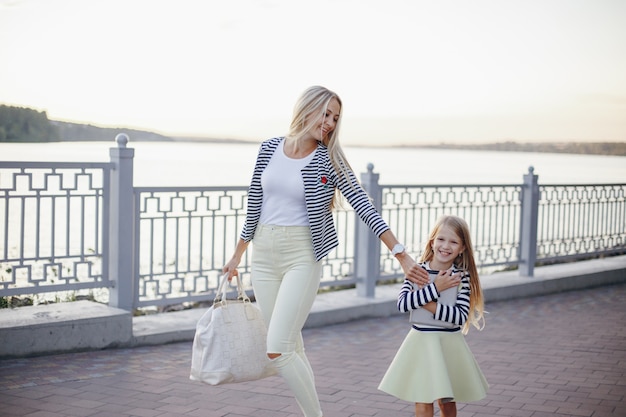 Mother and daughter dressed in the same colors walking