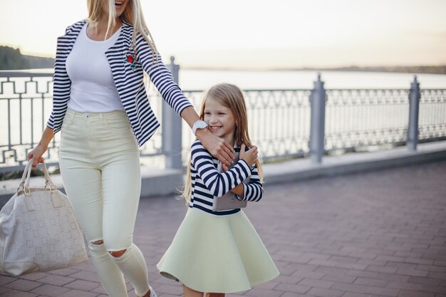 Mother and daughter dressed in the same colors walking