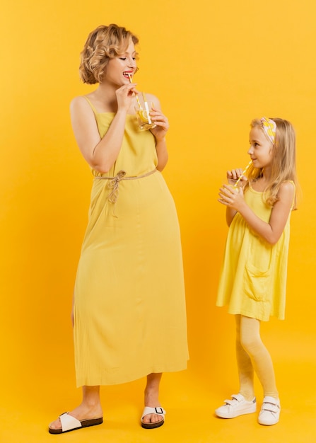 Mother and daughter drinking lemonade