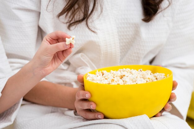 Mother and daughter eating popcorn