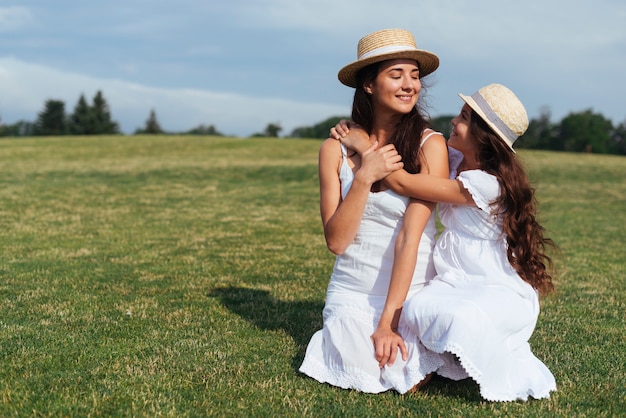 Mother and daughter embracing outdoors