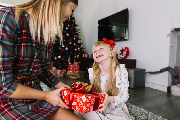 Mother and daughter exchanging gift box