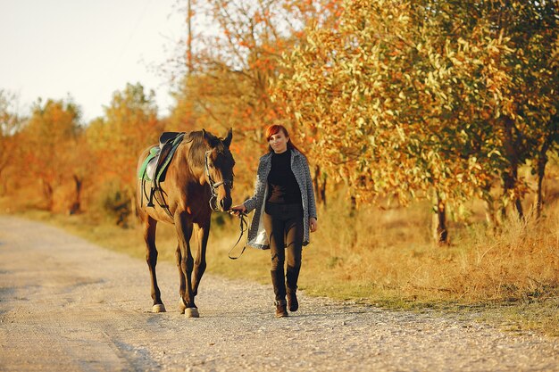 Mother and daughter in a field playing with a horse