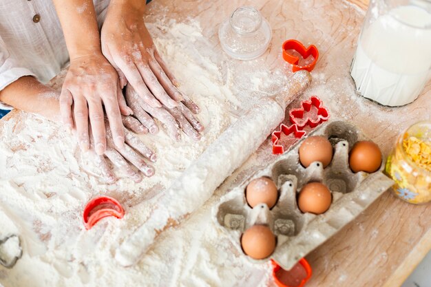 Mother and daughter hands making a dough