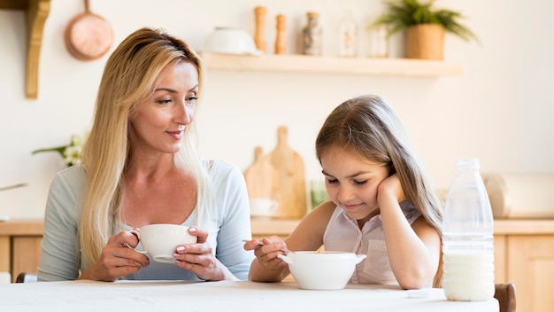 Mother and daughter having breakfast together