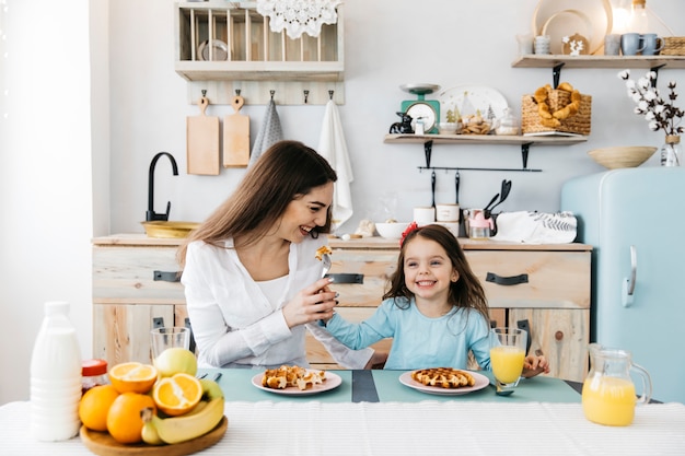 Mother and daughter having breakfast