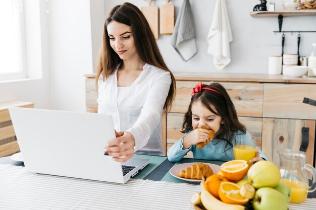 Mother and daughter having breakfast