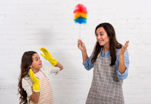 Mother and daughter having fun cleaning