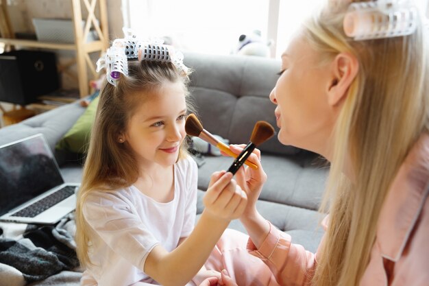 Mother and daughter having fun day together at home