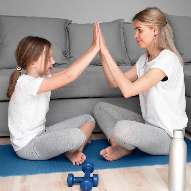 Free photo mother and daughter high five