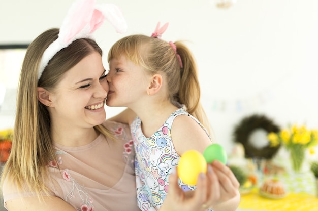 Mother and daughter holding eggs