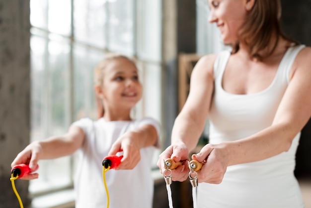 Mother and daughter holding jump ropes