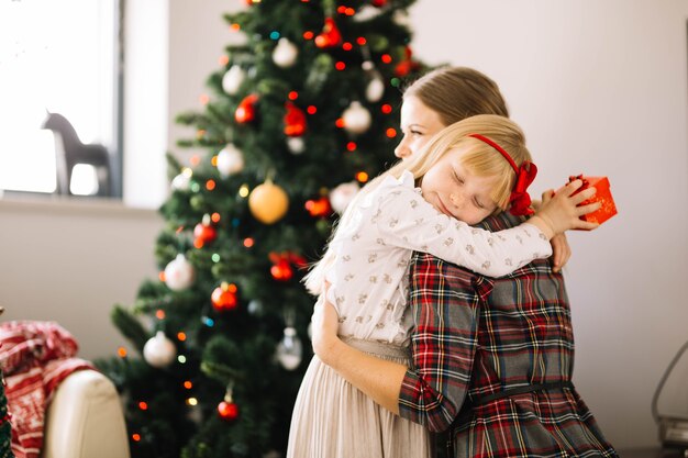 Mother and daughter hugging at christmas