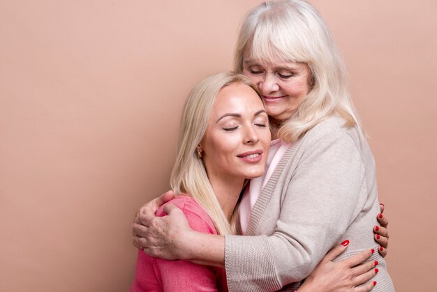 Mother and daughter hugging each other