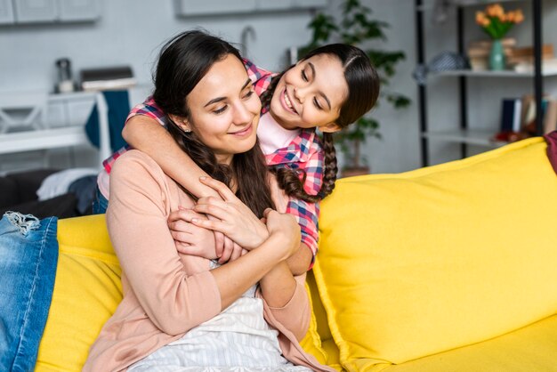 Mother and daughter hugging each other